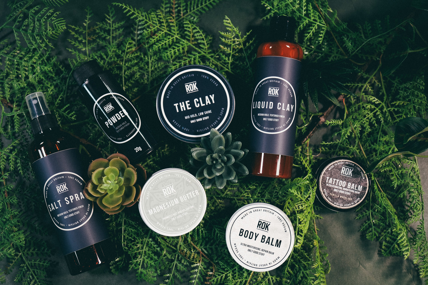ROK Products full hair care range on green fern background – The Clay, Liquid Clay, Powder, Salt Spray, Magnesium Butter, Body Balm and Tattoo Balm
