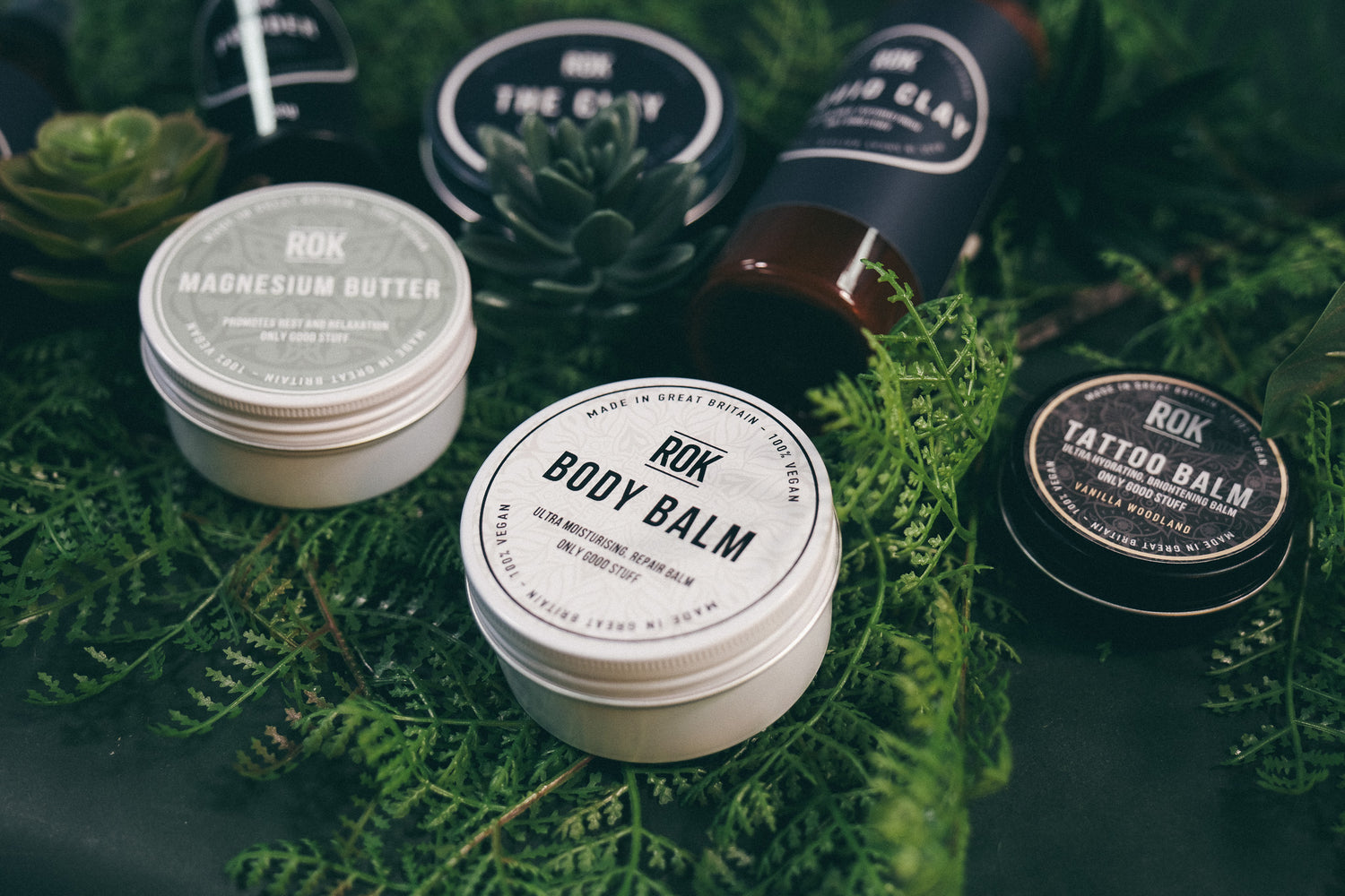Full ROK Products skincare range on green fern – Body Balm, Magnesium Butter, Tattoo Balm, Liquid Clay and The Clay