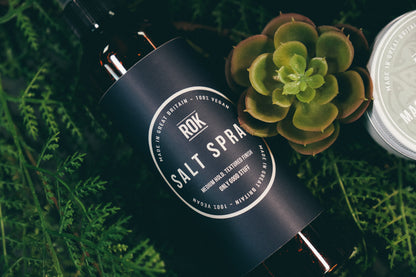 ROK Salt Spray bottle with succulent plant and Magnesium Butter tin on green foliage