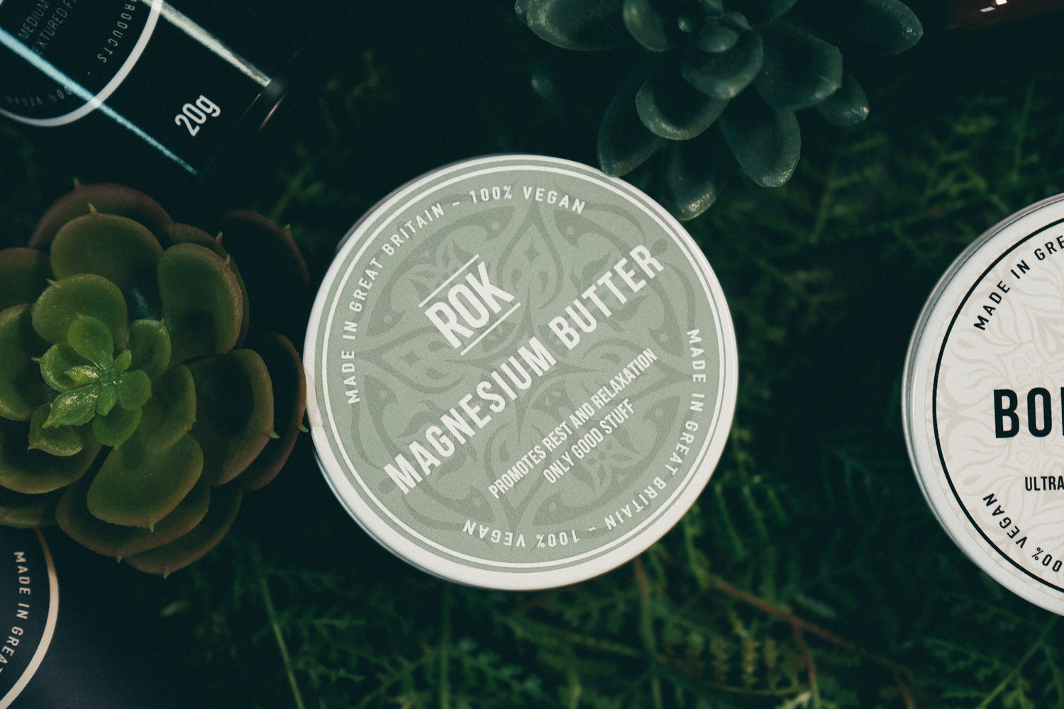 ROK Magnesium Butter tin surrounded by green foliage – natural vegan skincare product