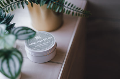 ROK Magnesium Butter jar on wooden surface with plants – natural body butter UK made