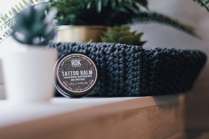 ROK Tattoo Balm tin with woven basket and tropical plant display – vegan tattoo care UK